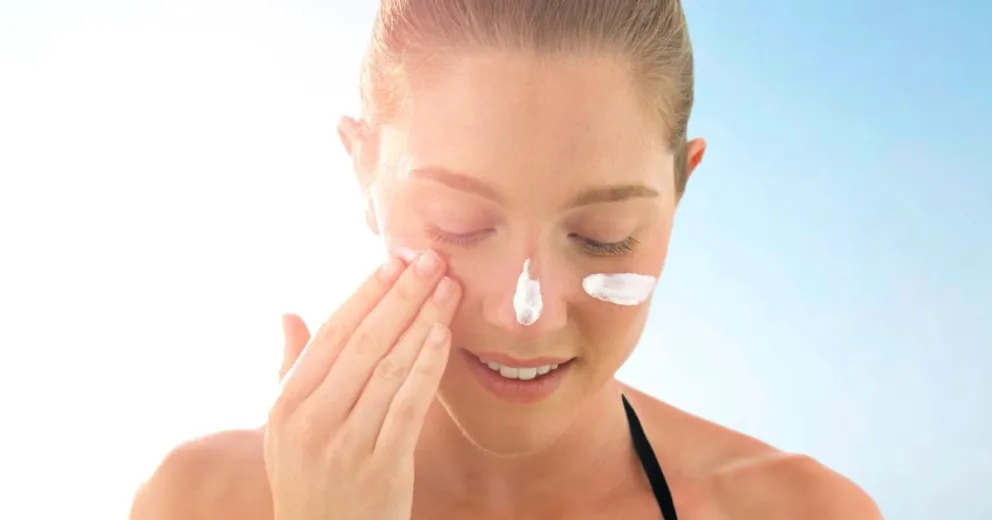 Woman applying sunscreen